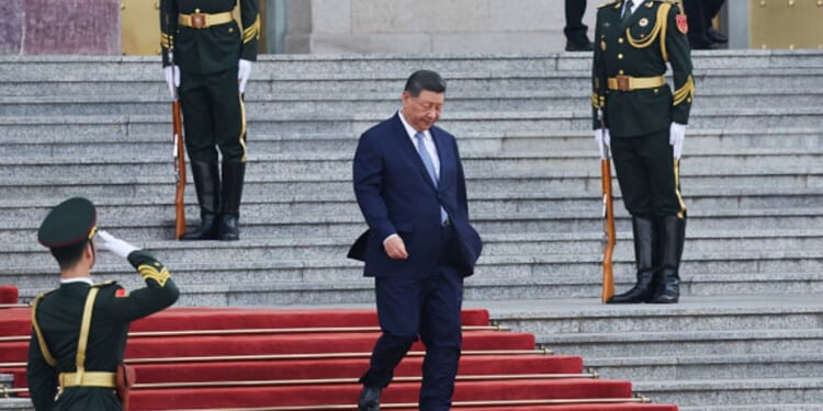 President Xi Jinping walks down the stairs of the Great Hall of the People on May 12, 2026 in Beijing, China.