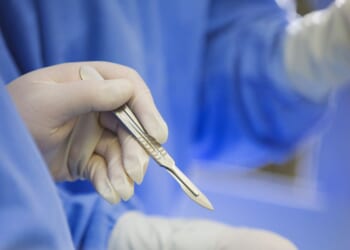 A surgeon using a scalpel during surgery.