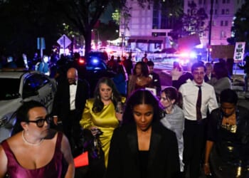 Outside the Washington Hilton on April 25, 2026 a crowd stands gathered after the shooting incident at the WHCD.