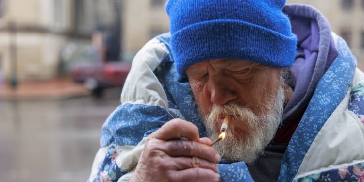 A man lighting a cigarette
