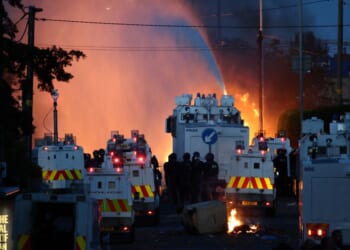 Police use a water cannon Wednesday as they block the road from protesters in Glengormley, north of Belfast, Northern Ireland.