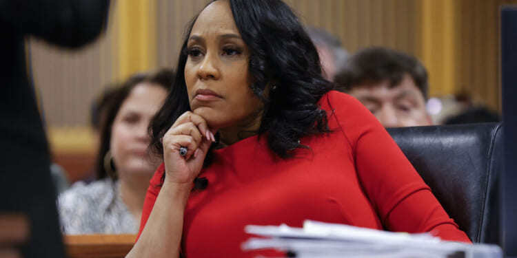 ATLANTA, GA - MARCH 01: Fulton County District Attorney Fani Willis looks on during a hearing in the case of the State of Georgia v. Donald John Trump at the Fulton County Courthouse on March 1, 2024, in Atlanta, Georgia. The hearing is to determine whether Fulton County District Attorney Fani Willis should be removed from the case because of a relationship with Nathan Wade, special prosecutor she hired in the election interference case against former President Donald Trump. (Photo by Alex Slitz-Pool/Getty Images)