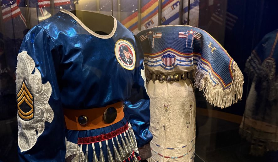 Two Native American dresses are on display as part of a commemoration of the 250th anniversary of the signing of the Declaration of Independence at the Smithsonian's National Museum of the American Indian in Washington, on Saturday, May 23, 2026. (Jourdan Bennett-Begaye/ICT via AP)