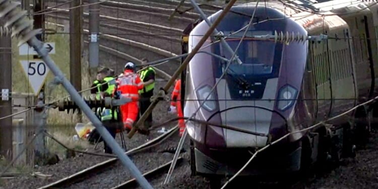 Two trains collide north of London, killing at least 1 person and seriously injuring dozens