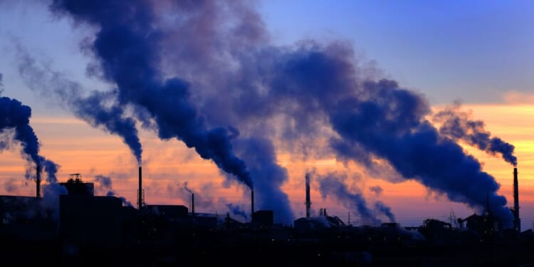 Pollution smoke from a factory plant pumping smoke into the air.