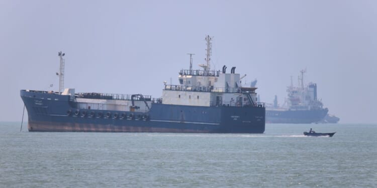 Iran moves to control commercial shipping in Strait of Hormuz, issues warning after vessel is struck