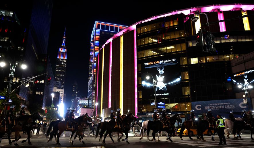 FILE - New York City police on horseback patrol the street by Madison Square Garden during Game 5 of the NBA Finals basketball series against the San Antonio Spurs, June 13, 2026, in New York. (AP Photo/Heather Khalifa, File)