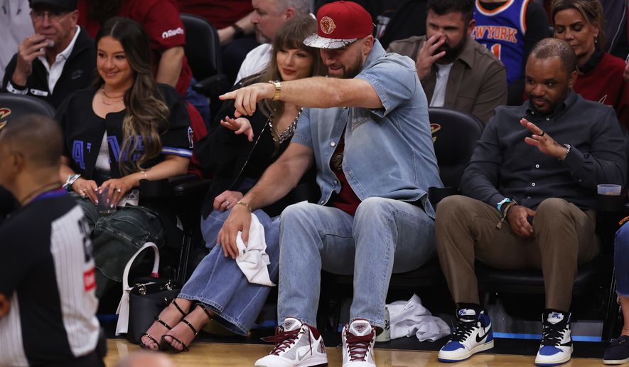 FILE - Taylor Swift and Travis Kelce watch the second half of Game 3 in the Eastern Conference finals NBA basketball playoffs series between the New York Knicks and the Cleveland Cavaliers in Cleveland, May 23, 2026. (AP Photo/Tim Phillis, File)