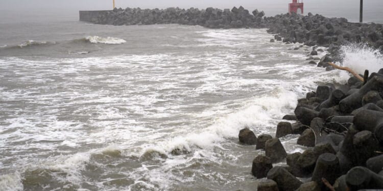 2 tropical storms pound Japan with floods and landslides, killing 1