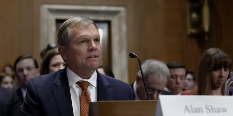 Alan Shaw, president and CEO of Norfolk Southern Corporation, seated