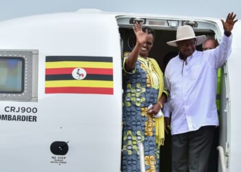 Ugandan President Yoweri Museveni (R) and First Lady Janet Museveni waving from a plane