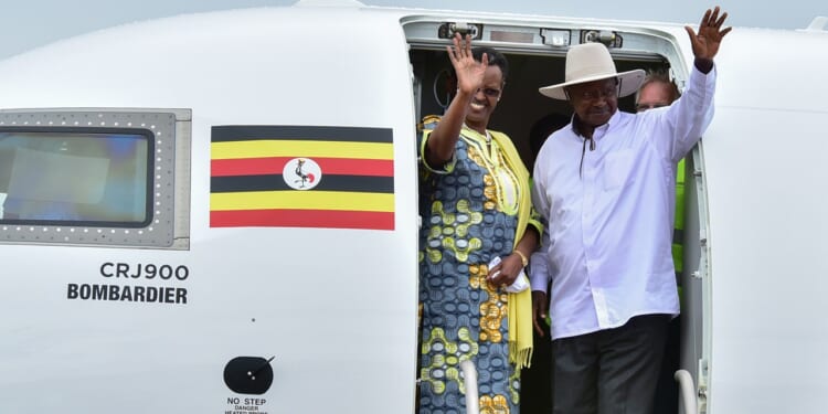 Ugandan President Yoweri Museveni (R) and First Lady Janet Museveni waving from a plane