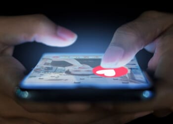 A woman uses her phone to navigate a dating app.