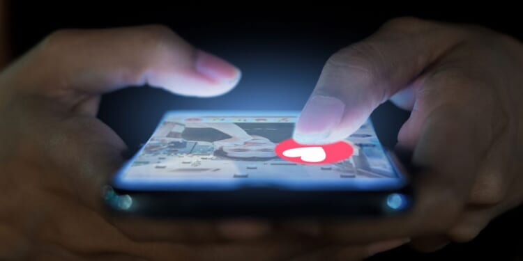 A woman uses her phone to navigate a dating app.