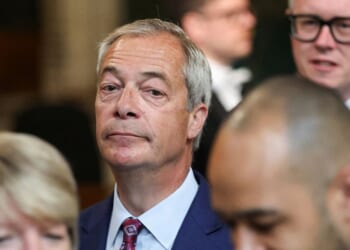 Reform UK leader Nigel Farage walks through the House of Commons at the Palace of Westminster in London on May 13, 2026.