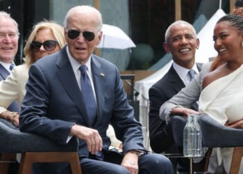 Former President Joe Biden listens to a performance by Stevie Wonder at the dedication ceremony for the opening of the Barack Obama Presidential Center in John Lewis Plaza on June 18, 2026, in Chicago, Illinois.