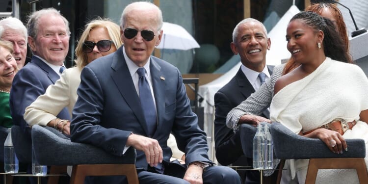 Former President Joe Biden listens to a performance by Stevie Wonder at the dedication ceremony for the opening of the Barack Obama Presidential Center in John Lewis Plaza on June 18, 2026, in Chicago, Illinois.