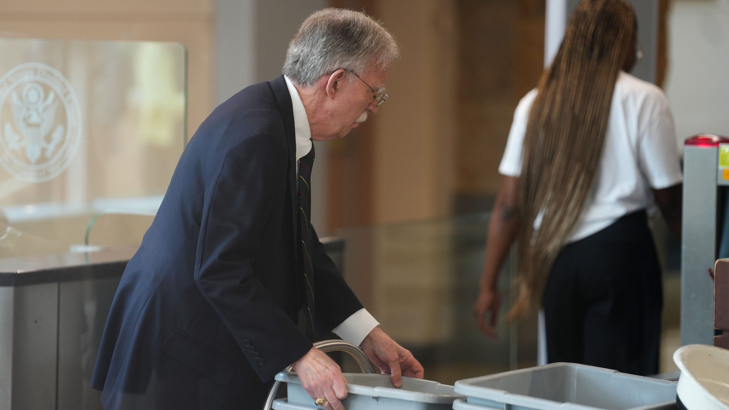 Former U.S. Ambassador to the United Nations and former National Security Advisor John Bolton walks through security as he arrives for a plea deal hearing at U.S. District Court for the District of Maryland on June 26, 2026 in Greenbelt, Maryland. Bolton is expected to plead guilty to one count of mishandling national security information. (Photo by Al Drago/Getty Images)