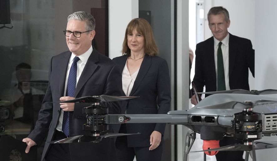 British Prime Minister Keir Starmer, left, followed by Chancellor of the Exchequer Rachel Reeves and Defense Secretary Dan Jarvis arrive for the announcement of a defense plan, in Berkshire, England, Tuesday, June 30, 2026. (Stefan Rousseau/Pool Photo via AP)