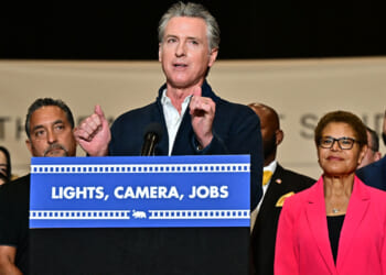 California Governor Gavin Newsom, alongside Los Angeles Mayor Karen Bass (2R), speaks at a news conference, where he announced a major expansion of the state's film and TV tax credit program, raising the cap to $750 million in an effort to keep entertainment productions in California, at the Ranch Lot Studios in Burbank, California on July 2, 2025. (Photo by Frederic J. BROWN / AFP) (Photo by FREDERIC J. BROWN/AFP via Getty Images)