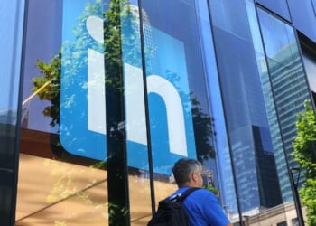 A pedestrian walks by a sign at a LinkedIn office on July 26, 2023, in San Francisco, California.