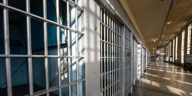 The sun shining on the bars of an historic prison.