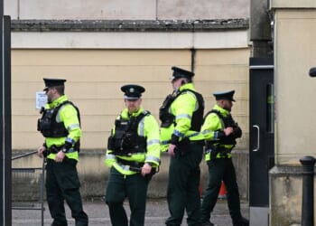 Police officers erect barriers as they prepare for the departure of Former DUP Leader Sir Jeffrey Donaldson from Newry court house on June 18, 2026, in Newry, Northern Ireland.