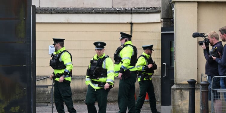 Police officers erect barriers as they prepare for the departure of Former DUP Leader Sir Jeffrey Donaldson from Newry court house on June 18, 2026, in Newry, Northern Ireland.