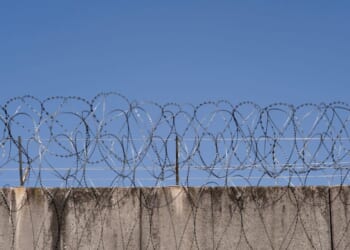 A prison wall with barbed wire in Frankfurt, Germany.