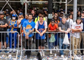 Fans look on during the New York Knicks Championship ticker tape parade and victory rally celebrating winning the 2026 NBA Finals on June 18, 2026, in New York City.