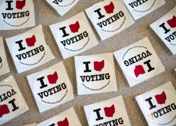 A table full of stickers to hand out to voters is shown.