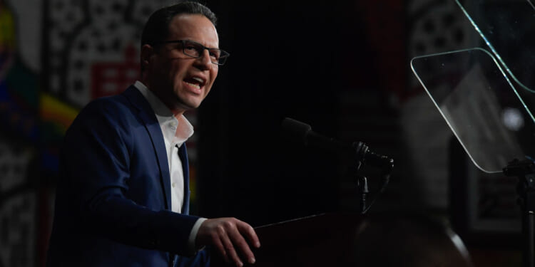 Pennsylvania Gov. Josh Shapiro speaks to supporters at a rally.