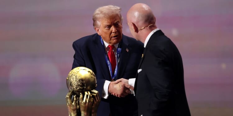 President Donald Trump receives the FIFA Peace Prize from Gianni Infantino, President of FIFA, during the FIFA World Cup 2026 Official Draw at John F. Kennedy Center for the Performing Arts on Dec. 5, 2025, in Washington, D.C.