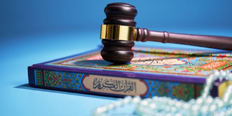 A gavel sits atop a Quran and Islamic prayer beads in a photo illustration.