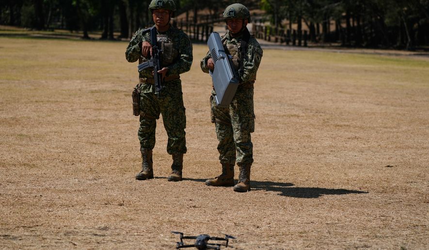 Soldiers from the Mexican Army's anti-drone squadron display the equipment and tactics they will use during the 2026 FIFA World Cup, during a media presentation in Mexico City, Friday, Feb. 27, 2026. (AP Photo/Marco Ugarte)