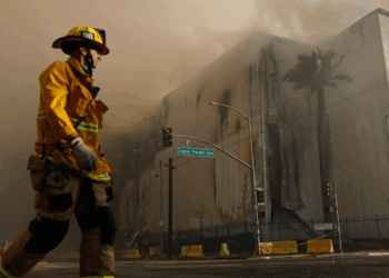 An LA City firefighter stands outside of the Boyle Heights warehouse fire.