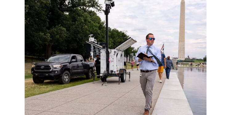 U.S. Park Police and contractors place security cameras along the Lincoln Memorial Reflecting Pool Thursday in Washington, D.C.