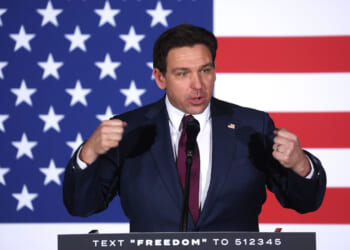 Ron DeSantis speaks in front of an American flag