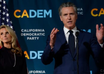 California Gov. Gavin Newsom and his wife, Jennifer Siebold Newsom, left, are pictured in a November file photo as election returns come in for a ballot measure that allowed California to redistrict its congressional delegation to elect more Democrats.