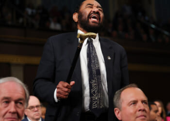 Rep. Al Green shakes his cane and screams toward President Trump.