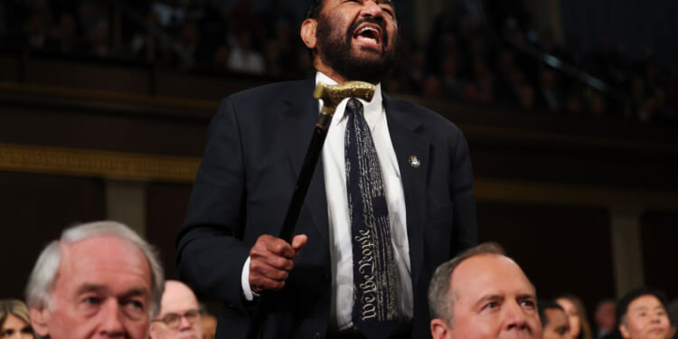 Rep. Al Green shakes his cane and screams toward President Trump.