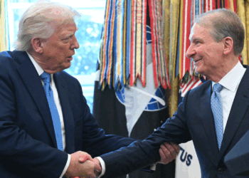 President Donald Trump (L) shakes hands with Paul Atkins, newly sworn-in as Chairman of the Securities and Exchange Commission., in the Oval Office of the White House on Washington, DC, April 22, 2025. Under Atkins, the SEC has dropped legal proceedings against major cryptocurrency platforms like Coinbase and Kraken that were initiated during former president Joe Biden's term. Biden's administration had implemented restrictions on banks holding cryptocurrencies -- which have since been lifted -- and allowed former SEC chairman Gary Gensler to pursue aggressive enforcement. (Saul Loeb//AFP via Getty Images)
