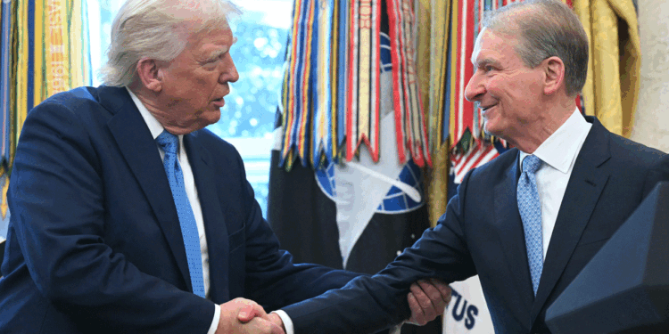 President Donald Trump (L) shakes hands with Paul Atkins, newly sworn-in as Chairman of the Securities and Exchange Commission., in the Oval Office of the White House on Washington, DC, April 22, 2025. Under Atkins, the SEC has dropped legal proceedings against major cryptocurrency platforms like Coinbase and Kraken that were initiated during former president Joe Biden's term. Biden's administration had implemented restrictions on banks holding cryptocurrencies -- which have since been lifted -- and allowed former SEC chairman Gary Gensler to pursue aggressive enforcement. (Saul Loeb//AFP via Getty Images)