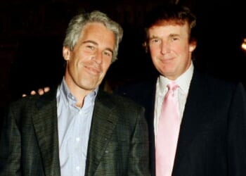 Then-financier Jeffrey Epstein, left, and then-real estate developer Donald Trump pose together at the Mar-a-Lago estate in Palm Beach, Florida, in a file photo dated Feb. 22, 1997. Their relationship soured not long after, and new evidence indicates Epstein was actively trying to find dirt on Trump when he died in prison in 2019.