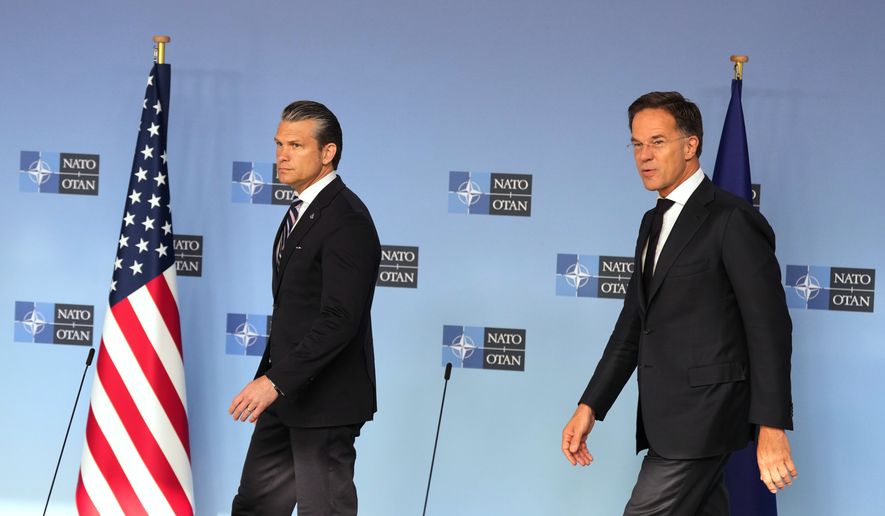 United States Defense Secretary Pete Hegseth, left, and NATO Secretary General Mark Rutte arrive for a media conference during a meeting of NATO defense ministers at NATO headquarters in Brussels, Thursday, June 18, 2026. (AP Photo/Virginia Mayo)