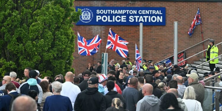 Demonstrators protest Tuesday outside of Southampton Central Police Station in Southampton, southern England, following the conviction of Vickrum Digwa for the murder of Henry Nowak.