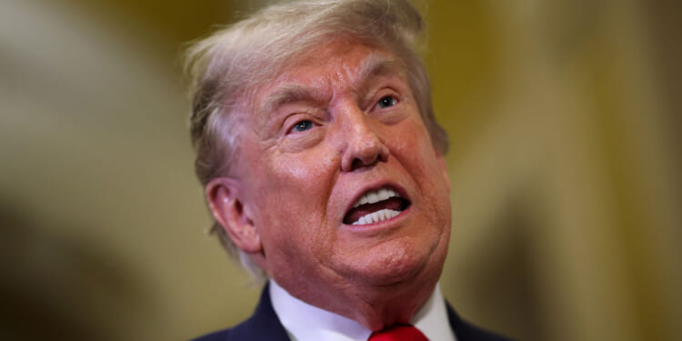 President Donald Trump speaks to reporters at the Capitol.