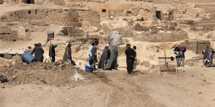 Workers walk through an archeological site in Egypt in February of 2018.