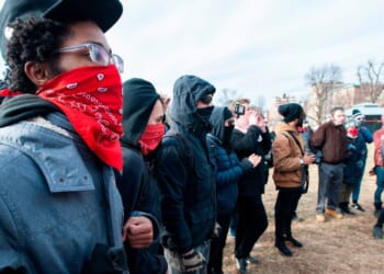 Antifa members form a circle and surround helmeted members of a right wing and pro-Trump group during the 2019 Women's March at Boston Common in Boston, Massachusetts, on Jan. 19, 2019.