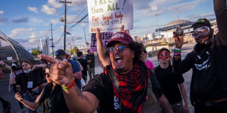 Protesters shout at ICE agents outside the Delaney Hall Immigration Detention Center on June 7, 2026, in Newark, New Jersey.
